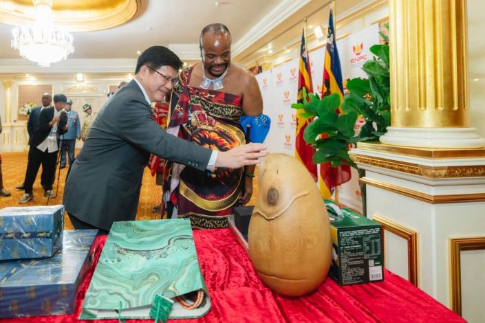 圖說四：總統特使林佳龍向史瓦帝尼王國國王恩史瓦帝三世（H.M. King Mswati III）介紹我國著名雕塑家康木祥所贈木雕作品「無限智」。