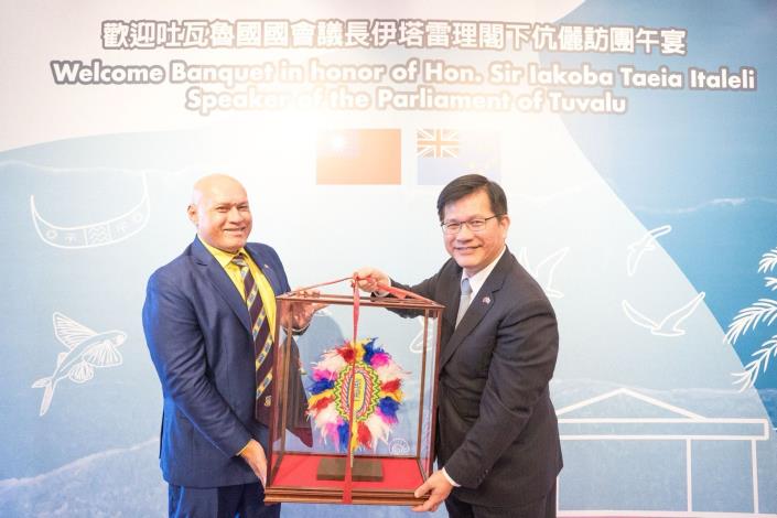 圖說四：吐瓦魯國國會議員潘賽威（Seve Paeniu）（左一）代表訪團致贈禮品予外交部長林佳龍（右一）。
