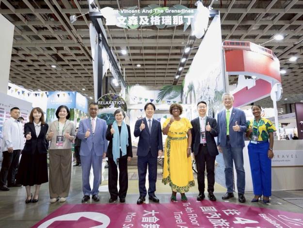 圖說三：賴總統（中）、台灣觀光協會會長簡余晏（左一）、外交部政務次長吳志中（右二）與聖文森及格瑞那丁駐台大使柏安卓（Andrea Clare Bowman，右四）參觀聖國展攤。