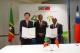 2.	Minister Wu (left) and Foreign Minister Douglas (right) sign an agreement on diplomatic staff training cooperation with Prime Minister Drew (center) as witness. 