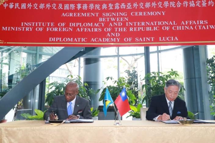 Caption[1]: Deputy Minister Tien (right) and Ambassador Laurent (left) sign the agreement.