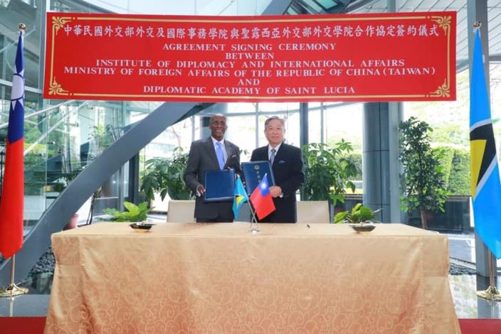 Caption[2]: Deputy Minister Tien (right) and Ambassador Laurent (left) pose for a photo after signing the agreement.